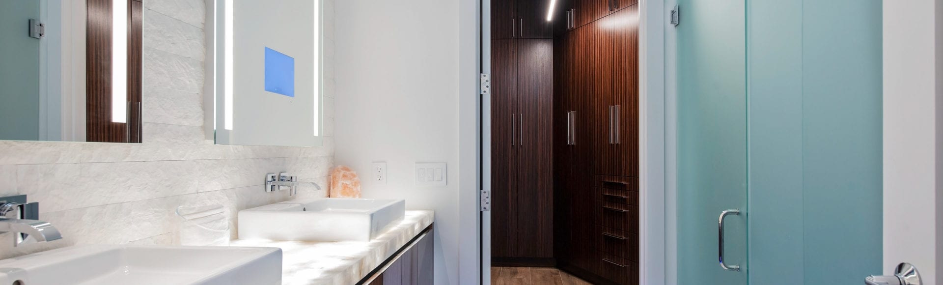 Illuminated countertop and mirrors in bathroom