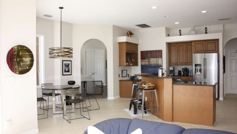 Kitchen with white archway and brown cabinets