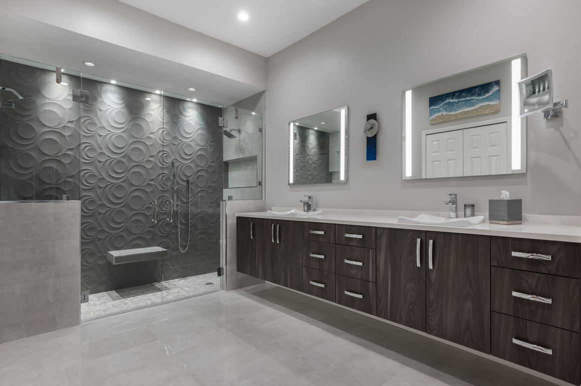 Bathroom with floating cabinets and 3D tile in shower