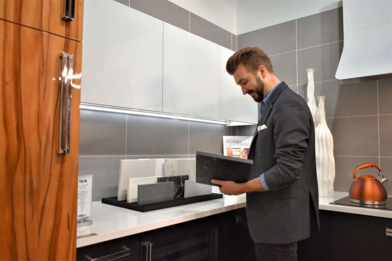 Male designer looking at black tile sample