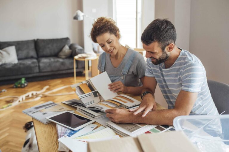 Man and woman with house plans and color samples