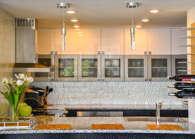 Kitchen with glossy white cabinets
