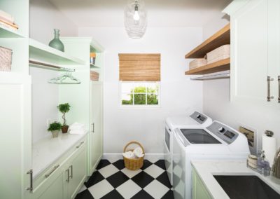 Retro laundry room with green cabinets