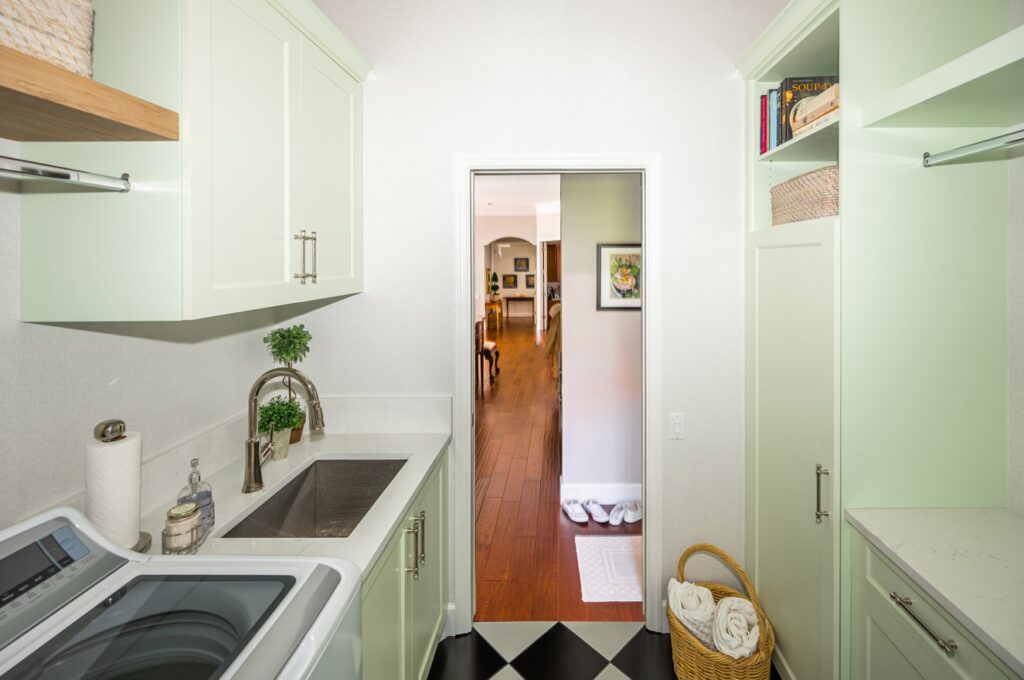 Retro laundry room with green cabinets