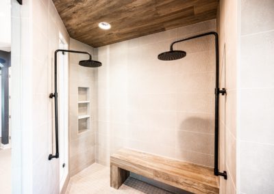 Shower with wood tile ceiling and two showerheads