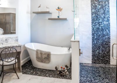 Crab sculpture by tub on pebble mosaic floor