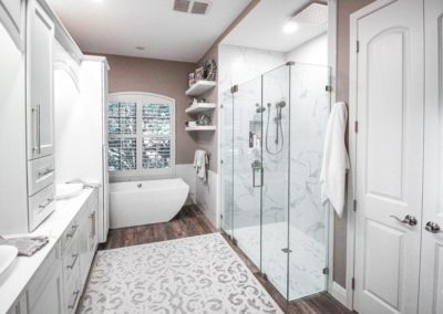 Bathroom with glass shower doors and freestanding tub