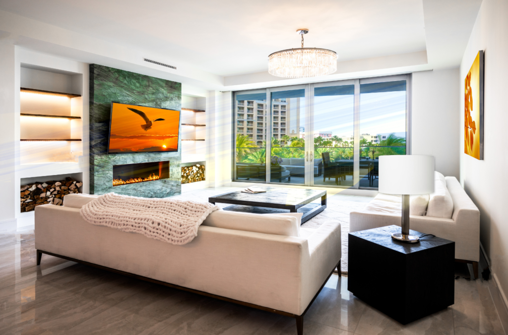 Living room with green fireplace surround and sofas