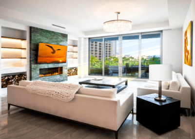 Living room with green fireplace surround and sofas