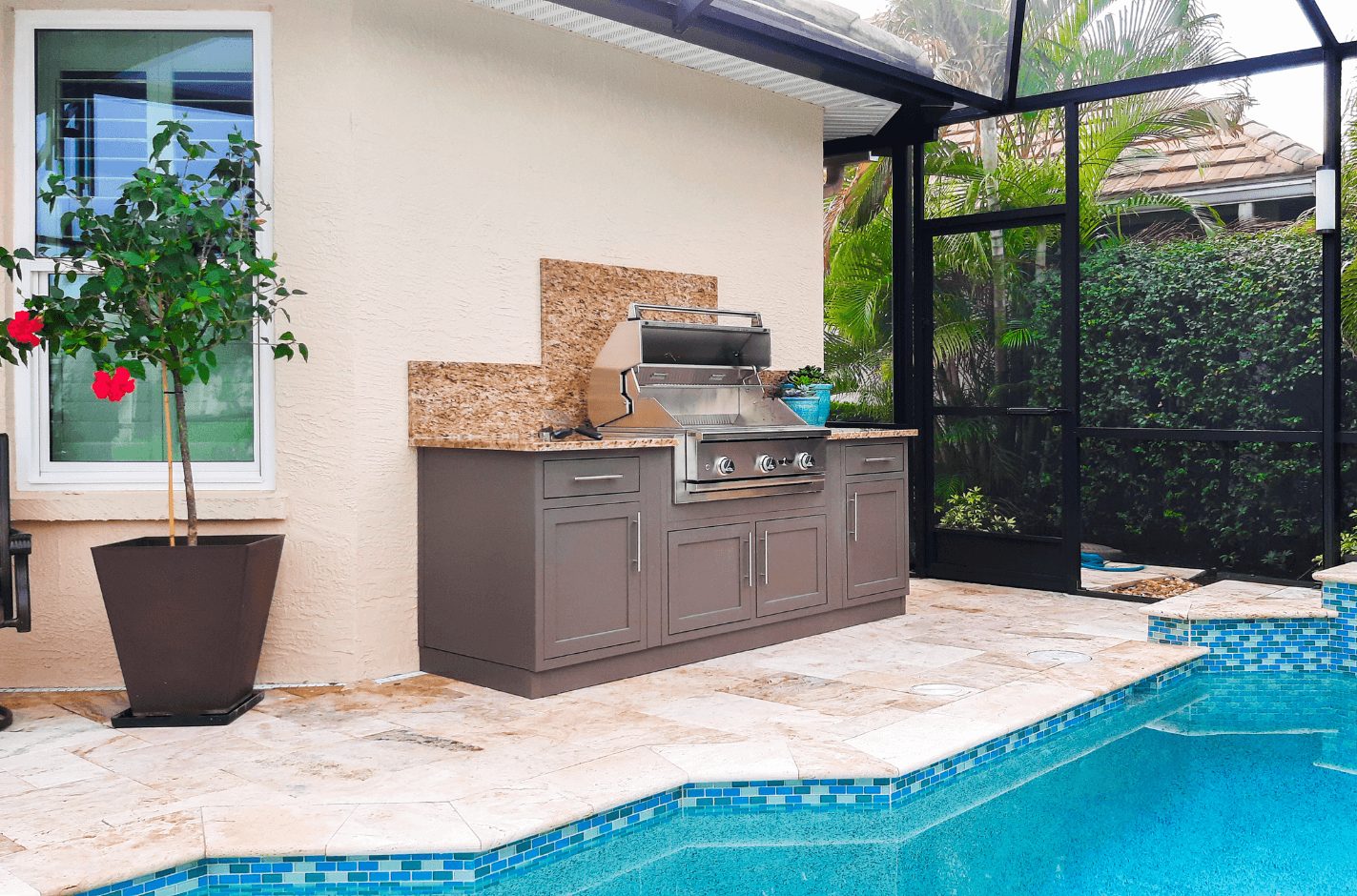 Outdoor kitchen and grill by pool