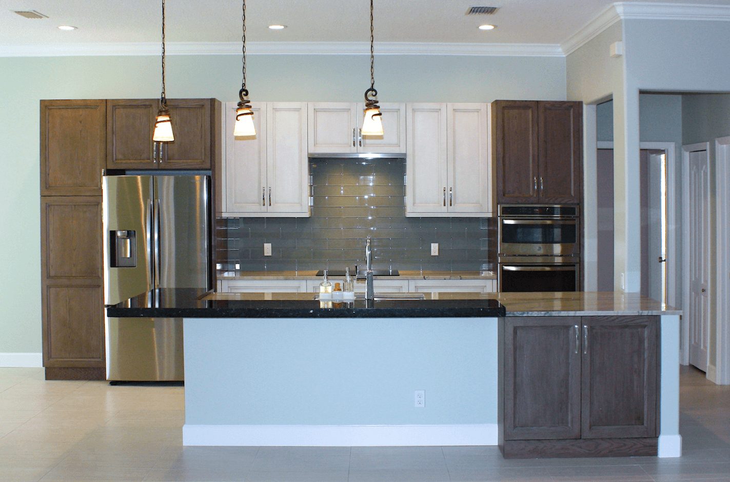 Blue kitchen with brown and white cabinets