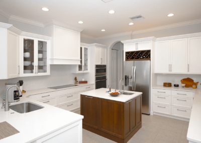 White kitchen with brown center island