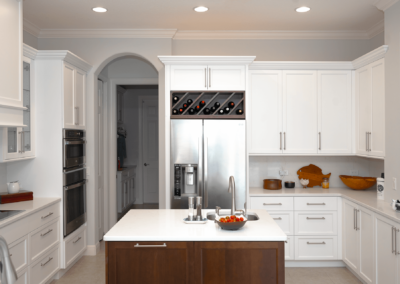 White kitchen with brown center island