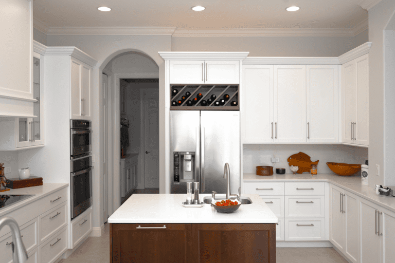 White kitchen with brown center island