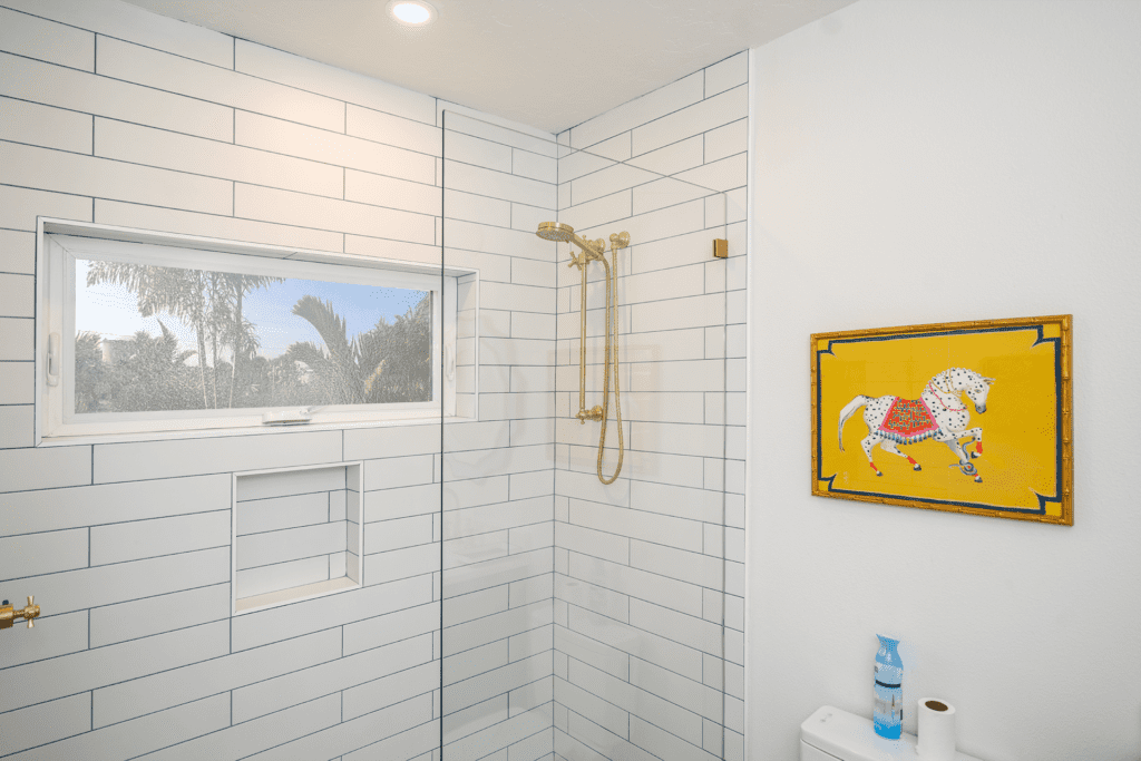 White tile shower and yellow painting