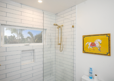 White tile shower and yellow painting