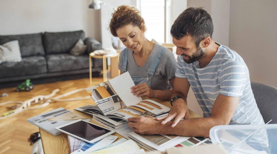 Man and woman with house plans and color samples