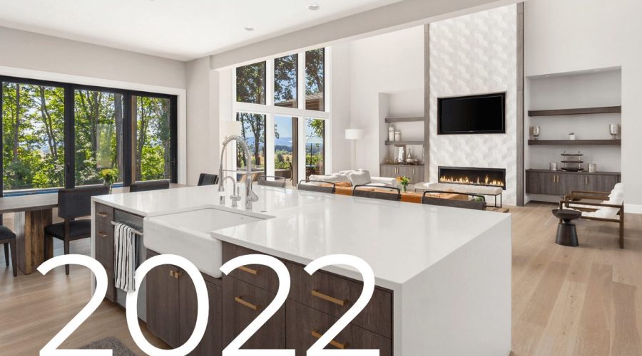 Beautiful kitchen and living room in new luxury home with open floor plan. Features large kitchen island and large bank of windows in living room